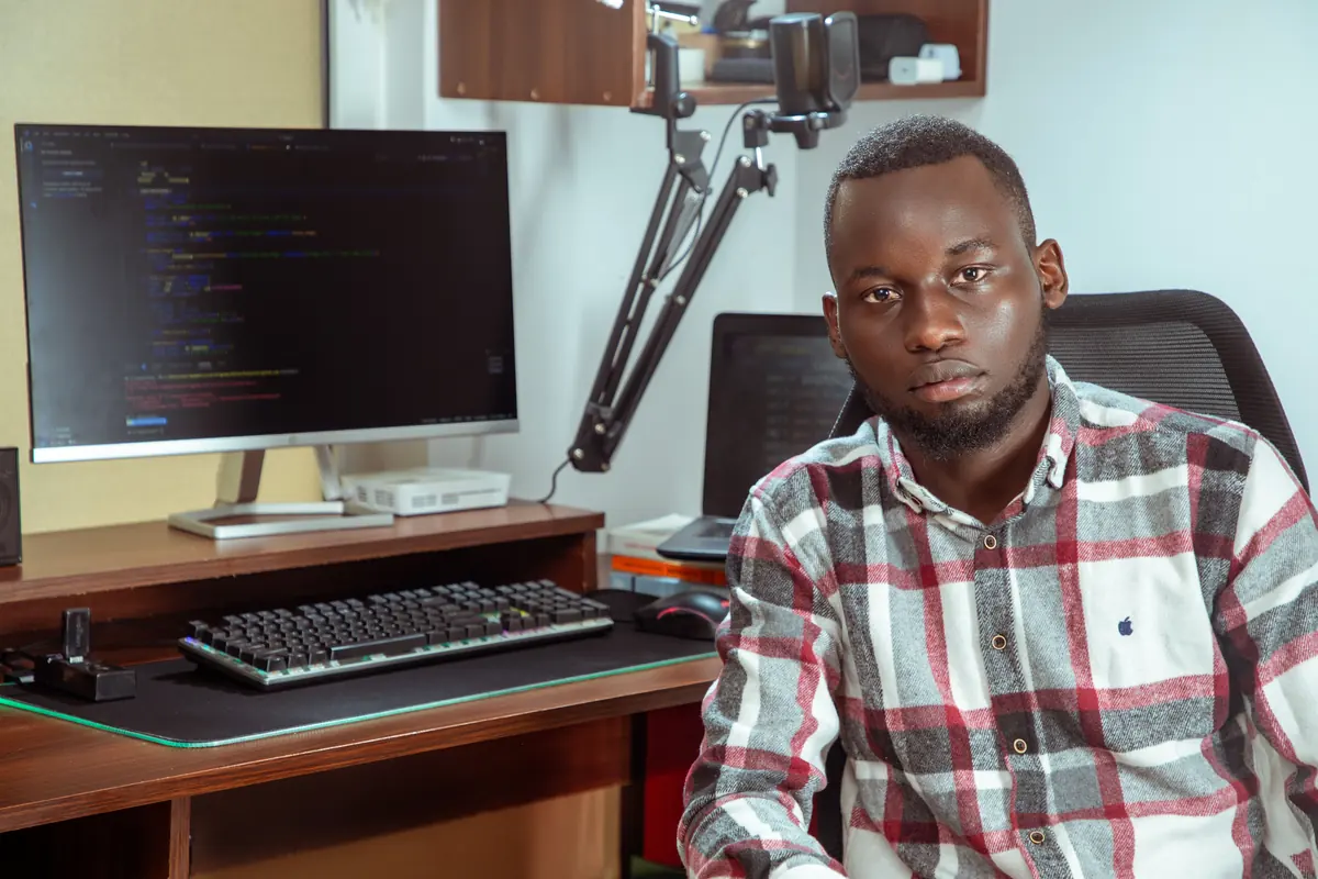 A software developer at a desk with two screens